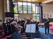 Our conductor Lucas accompanies  El Condor Pasa on guitar